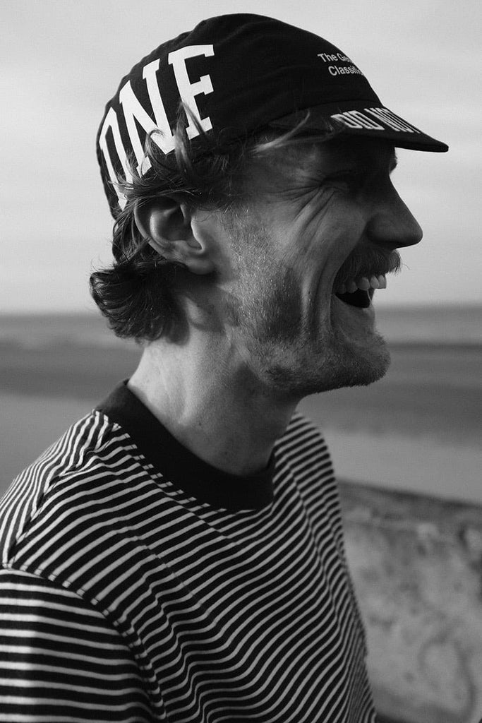 Black and White image of man wearing cycling cap
