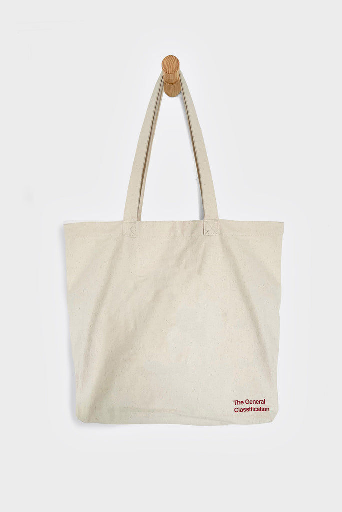 Beige tote bag with 'The General Distribution' logo on a white background